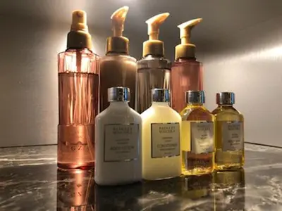 a group of four bottles of oil on a table at HOTEL VARKIN Ikebukuro Nishiguchi in Tokyo
