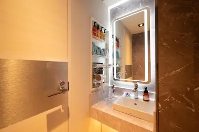 a bathroom with a sink and a mirror at HOTEL VARKIN Ikebukuro Nishiguchi in Tokyo