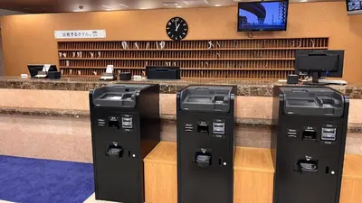 three parking meters in front of a cash counter at Toyoko Inn Tokyo Ikebukuro Kita guchi No 2 in Tokyo