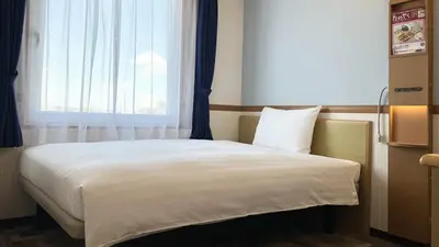 a bed in a room with a large window at Toyoko Inn Tokyo eki Shin ohashi Mae in Tokyo