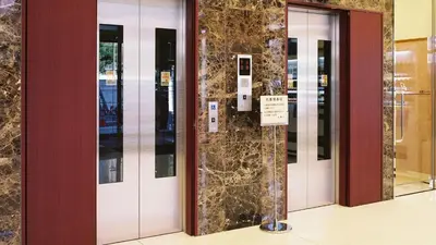 a row of elevator doors in a building at Toyoko Inn Tokyo eki Shin ohashi Mae in Tokyo