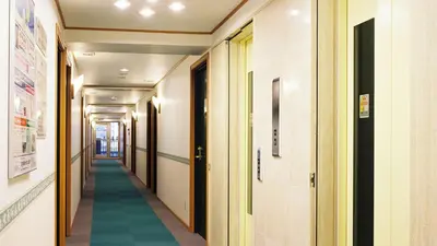 a hallway of a hospital with a green floor at Toyoko Inn Tokyo eki Shin ohashi Mae in Tokyo
