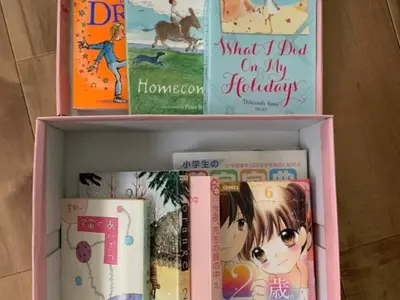 three books sitting on top of a book shelf at Peace Inn SkytreeTokyo - Vacation STAY 71958v in Tokyo