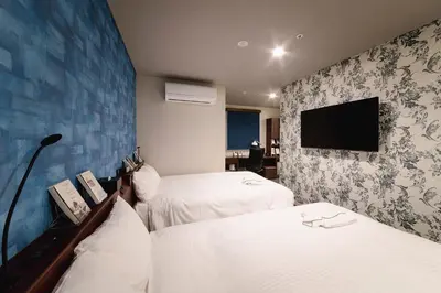 a hotel room with two beds and a flat screen tv at No, 2 Taniji Building - Vacation STAY 91347v in Tokyo