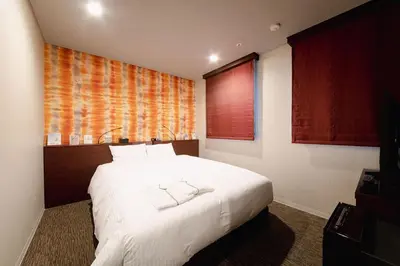 a bedroom with a large white bed and a window at No, 2 Taniji Building - Vacation STAY 92282v in Tokyo