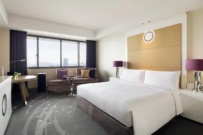 a hotel room with a large bed and a desk at Tokyo Marriott Hotel in Tokyo