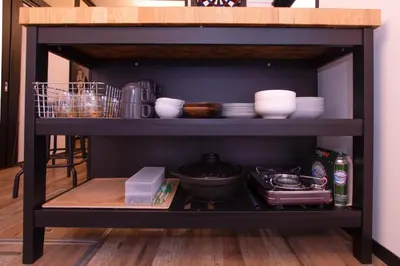 a black shelf with dishes and bowls on it at FuwaFuwa - Vacation STAY 12411 in Tokyo
