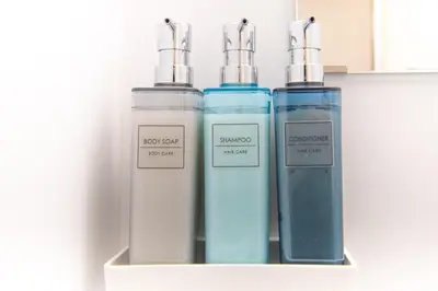 a group of three bottles sitting on a shelf at FuwaFuwa - Vacation STAY 12411 in Tokyo