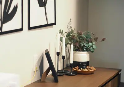 a table with a vase with a plant and candles at LANG HOTEL Kameido#Near Akihabara#\u30c1\u30a7\u30c3\u30af\u30a2\u30a6\u30c8\u306e\u307f\u6e05\u6383\u3042\u308a in Tokyo
