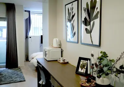 a room with a desk with a microwave on it at LANG HOTEL Kameido#Near Akihabara#\u30c1\u30a7\u30c3\u30af\u30a2\u30a6\u30c8\u306e\u307f\u6e05\u6383\u3042\u308a in Tokyo