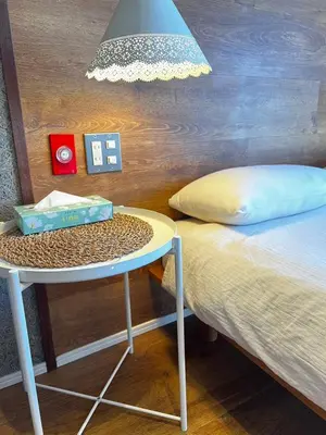 a bed and a table next to a bed and a lamp at Shinjuku 1003-SJ0303 in Tokyo