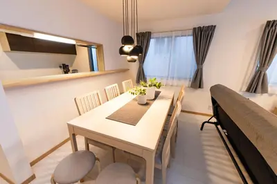 a dining room with a table and chairs at Y's HOTEL KAMEARI in Tokyo