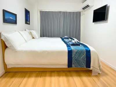 a bedroom with a large bed in a room at Rosenheim Tokyo Shinjuku in Tokyo