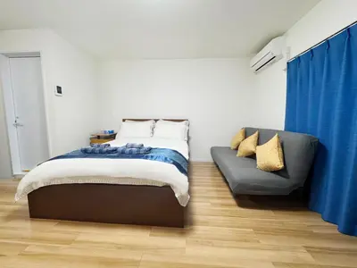 a bedroom with a bed and a couch at Rosenheim Tokyo Shinjuku in Tokyo