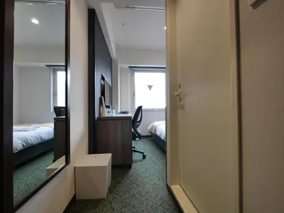 a bedroom with a mirror and a desk and a bed at Hotel Comfybed Ginza in Tokyo