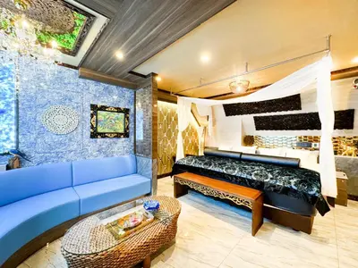 a living room with a blue couch and a table at Hotel BaliBali ANNEX \u4e94\u53cd\u7530 in Tokyo