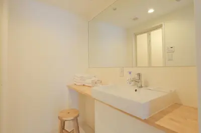 a white bathroom with a sink and a mirror at Hotel FANDINA TOKYO -\u30d5\u30a1\u30f3\u30c7\u30a3\u30fc\u30ca\u6771\u4eac- in Tokyo