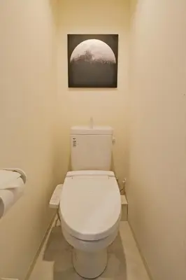 a bathroom with a toilet with a picture on the wall at Hotel FANDINA TOKYO -\u30d5\u30a1\u30f3\u30c7\u30a3\u30fc\u30ca\u6771\u4eac- in Tokyo