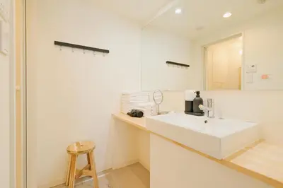 a white bathroom with a sink and a mirror at Hotel FANDINA TOKYO -\u30d5\u30a1\u30f3\u30c7\u30a3\u30fc\u30ca\u6771\u4eac- in Tokyo