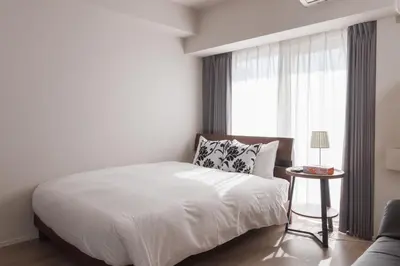 a white bedroom with a bed and a window at LANG HOTEL Kameido-2#Near Akihabara#\u30c1\u30a7\u30c3\u30af\u30a2\u30a6\u30c8\u306e\u307f\u6e05\u6383\u3042\u308a in Tokyo
