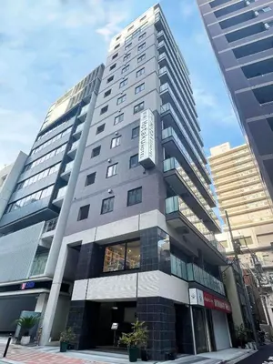 a tall building with a sign on the side of it at Hotaku HOTEL Akihabara in Tokyo
