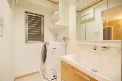 a bathroom with a sink and a washing machine at Hotaku HOTEL Akihabara in Tokyo
