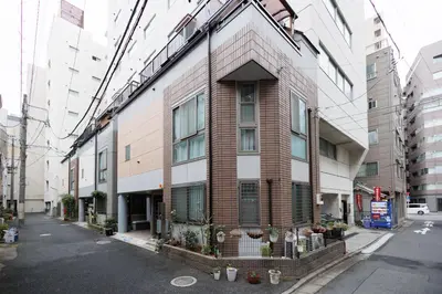 a tall brick building on a city street at Hotaku HOTEL Akihabara in Tokyo