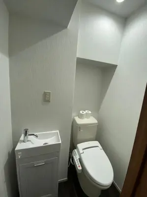 a small bathroom with a toilet and a sink at Takemura Building 2nd floor in Tokyo