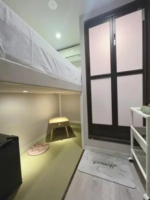 a room with a loft bed and a window at \u8aa0\u5bb6\u3000MAKOTO HOSTEL in Tokyo