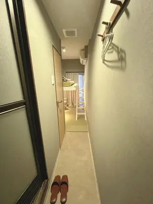 a hallway with two pairs of shoes in a room at \u8aa0\u5bb6\u3000MAKOTO HOSTEL in Tokyo