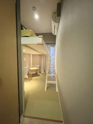 a small room with bunk beds and a ladder at \u8aa0\u5bb6\u3000MAKOTO HOSTEL in Tokyo