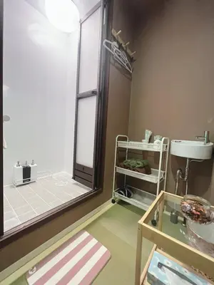 a bathroom with a shower and a sink and a mirror at \u8aa0\u5bb6\u3000MAKOTO HOSTEL in Tokyo