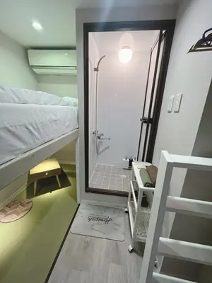 a bathroom with a shower and a bunk bed at \u8aa0\u5bb6\u3000MAKOTO HOSTEL in Tokyo