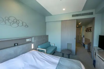 a hotel room with a bed and a chair and a television at La Vista Tokyo Bay in Tokyo