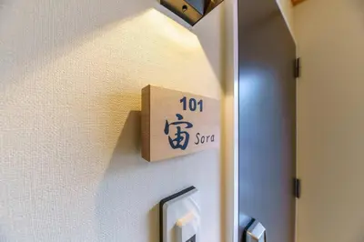 a sign on the wall of a room with a sign on it at YADOYA Fukurou in Tokyo