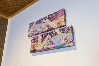 two pieces of art hanging on a wall at YADOYA Suzume in Tokyo