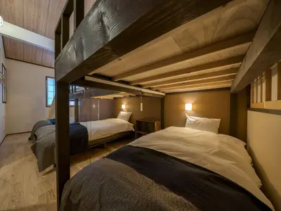 two beds in a room with two loft beds at YADOYA Matsugaya in Tokyo