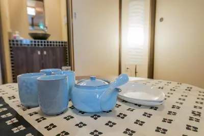 a table with blue cups and a plate on it at YADOYA Matsugaya in Tokyo