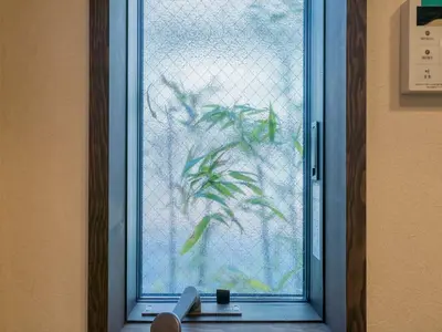 a glass door with a plant drawn on it at YADOYA Matsugaya in Tokyo