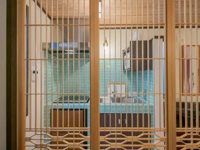 a room with bars on a room with a table at YADOYA Matsugaya in Tokyo