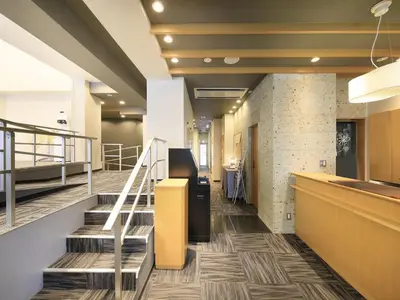 a lobby of an office building with stairs at Tamayura Hotel Asakusa in Tokyo