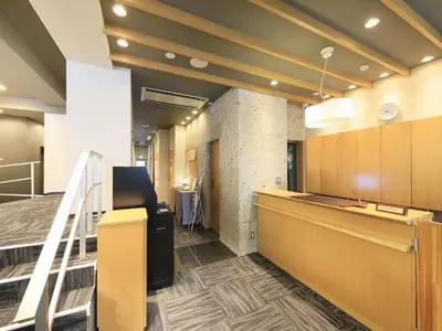 an office lobby with a counter and a staircase at Tamayura Hotel Asakusa in Tokyo