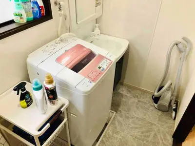 a washer and dryer in a kitchen with a counter at Guest house \u83ef\u97f3 in Tokyo