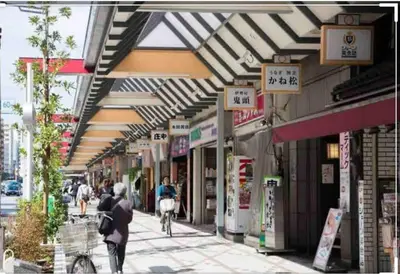 a street with people walking down a street with shops at Guest house \u83ef\u97f3 in Tokyo