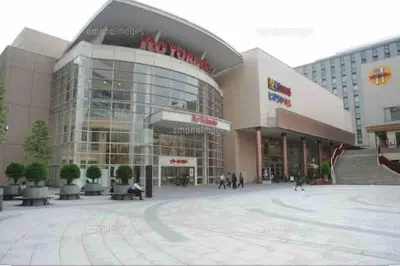 a large building with people walking in front of it at Guest house \u83ef\u97f3 in Tokyo