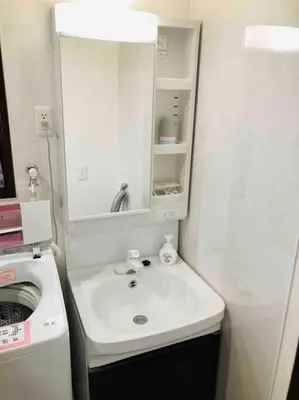 a bathroom with a sink and a mirror at Guest house \u83ef\u97f3 in Tokyo