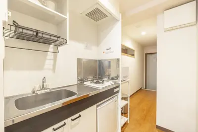 a kitchen with a sink and a counter at Dash Living Shinjuku in Tokyo