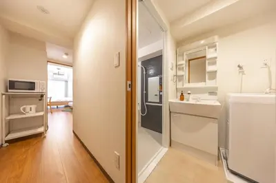 a small bathroom with a sink and a mirror at Dash Living Shinjuku in Tokyo