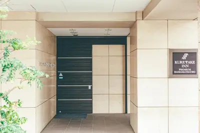 an entrance to a building with a black door at Kuretake Inn Premium Hamamatsucho in Tokyo
