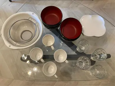 a group of cups and bowls on a glass table at \u56db\u8c37\u677e\u672c\u9928\u30d3\u30eb in Tokyo